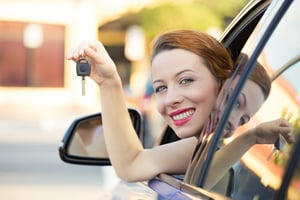 Closeup portrait happy, smiling, young attractive woman, buyer sitting in her new blue car showing keys isolated outside dealer, dealership lot, office. Personal transportation, auto purchase concept