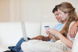 Couple shopping online in their living room